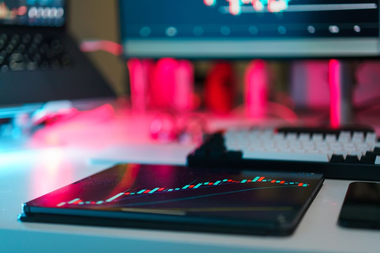 Services High-tech trading setup with charts on tablet and computer screens, representing data analysis and financial trends.